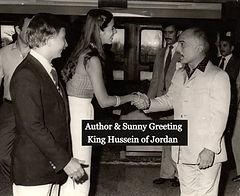A man and woman shaking hands with another man.